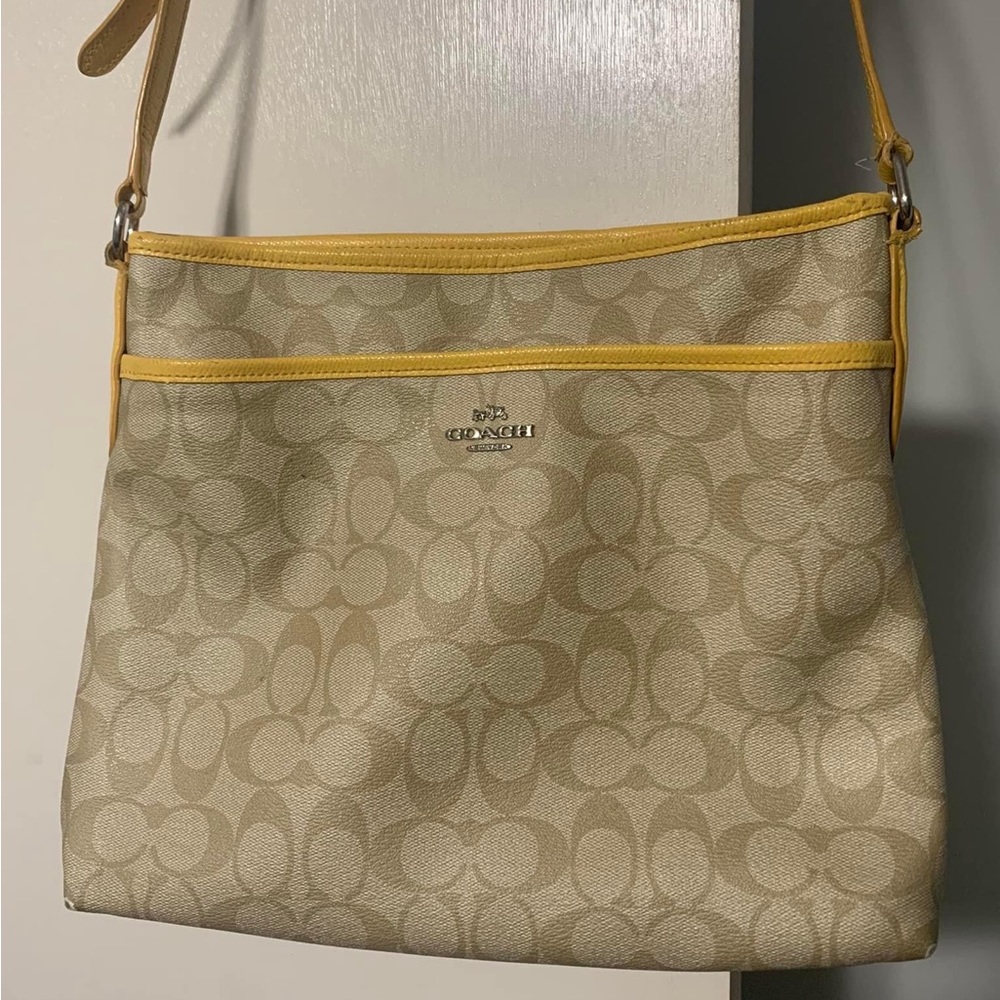 Coach leather monogram tan with yellow accent.